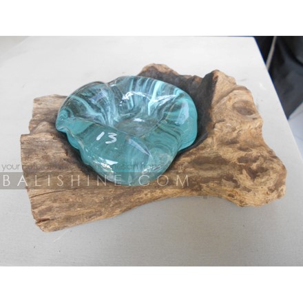 Balishine: Your natural source of indonesian handicraft presents in its Home Decor collection the Blown Glass Candle Holder Single on Teak Wood Stand:13INT168061:Unique mouth blown slumped glass single  candle holder crafted by talented glass artisans on the island of Bali. Recycled molten?glass is?slumped over the top of a reclaimed teak root base. This forms a unique glass scape as the molten glass drapes & flows and takes on the?gnarly?shape of the wood, so beautiful, almost looks like water droplets nestled in the crevices?of the wood.?   Because each item is handmade, shape and size can vary slightly and tiny bubbles may appear within the glass. This exemplifies the hand-blown technique, making every piece a unique example of blown glass craftsmanship.