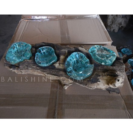 Balishine: Your natural source of indonesian handicraft presents in its Home Decor collection the Handmade Blown Glass Candle Holder on Teak Wood Stand:13INT168058:Unique mouth blown slumped glass triple candle holder crafted by talented glass artisans on the island of Bali. Recycled molten?glass is?slumped over the top of a reclaimed teak root base. This forms a unique glass scape as the molten glass drapes & flows and takes on the?gnarly?shape of the wood, so beautiful, almost looks like water droplets nestled in the crevices?of the wood.?   Because each item is handmade, shape and size can vary slightly and tiny bubbles may appear within the glass. This exemplifies the hand-blown technique, making every piece a unique example of blown glass craftsmanship.